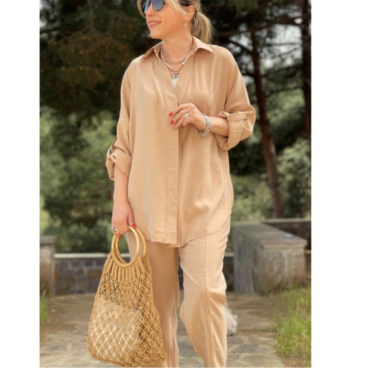 Khaki shirt and wide-leg cropped trouser set in a warm light tan, styled with a woven straw bag