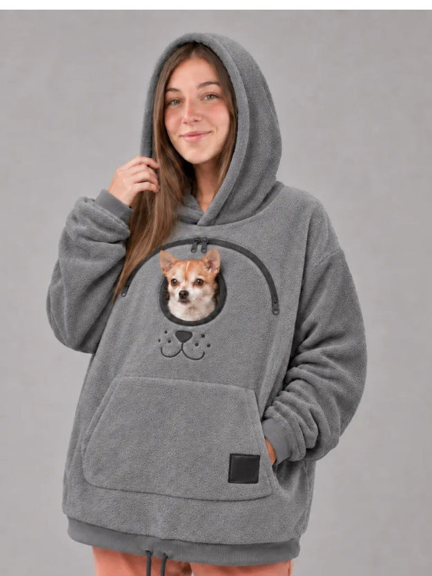 Grey oversized fleece pet carrier hoodie with a small dog resting in the front pouch