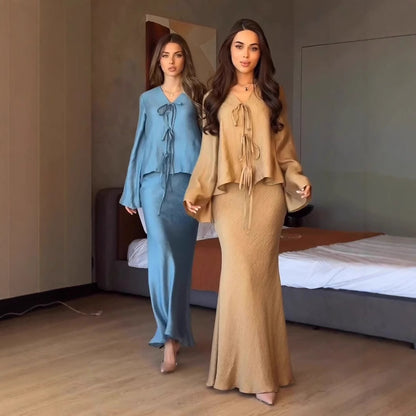 Crinkle satin set in khaki and teal modelled by two women walking in a softly lit room