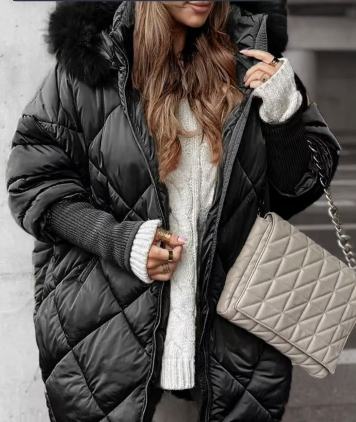 Women's black diamond-quilted hooded coat with a fluffy hood trim shown front on