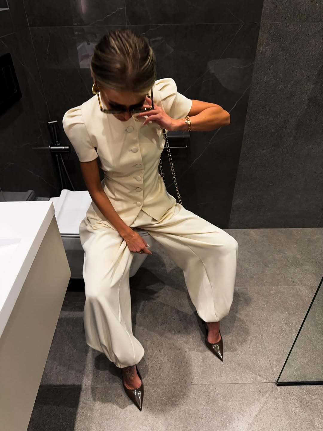 Cream peplum jacket and high-waisted wide-leg trousers shown styled on the model