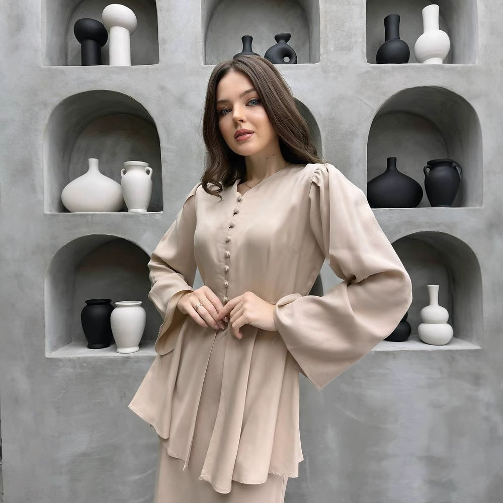 Champagne cardigan close-up showing the covered-button placket and waist flounce
