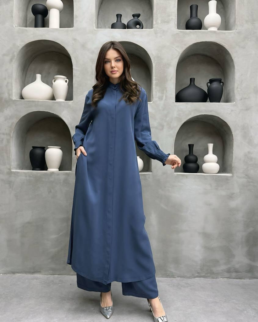 Blue long stand-collar shirt and straight-leg trouser two-piece set worn full length with the side split open over the trousers